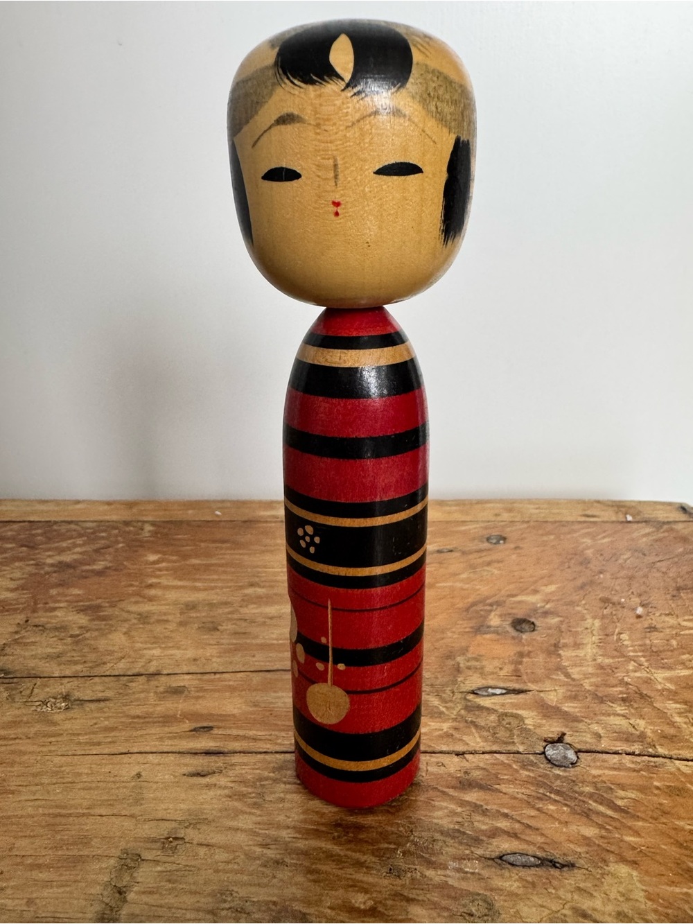 Vintage Japanese Wooden Kokeshi doll with red and black striped body